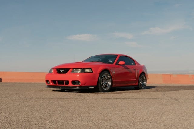 A red Ford Mustang, parked.