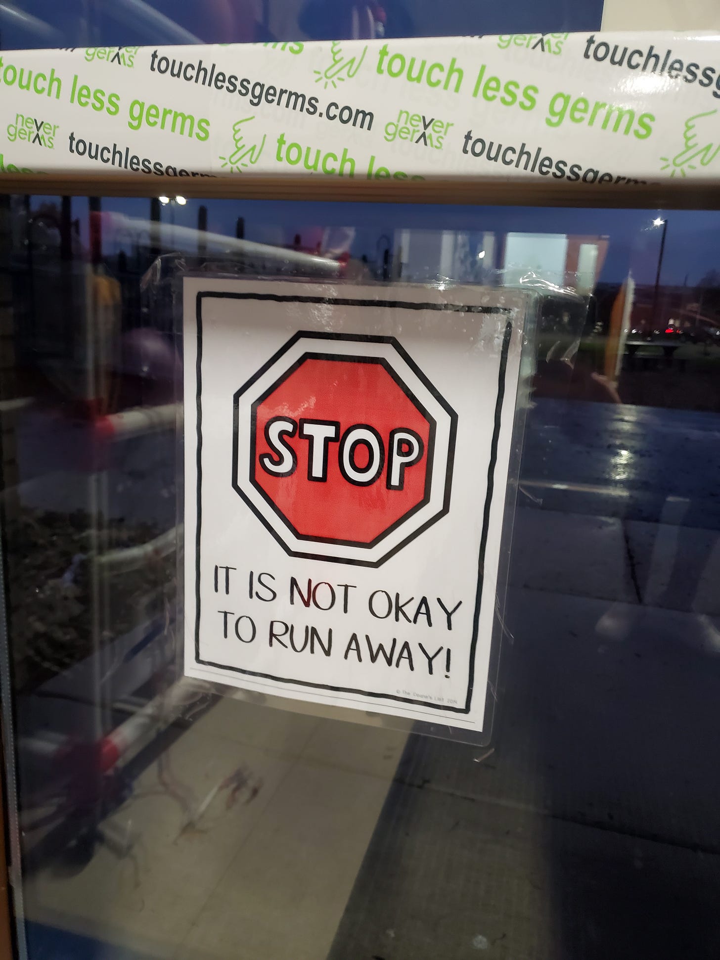 Stop sign with it is not okay to run away! underneath
