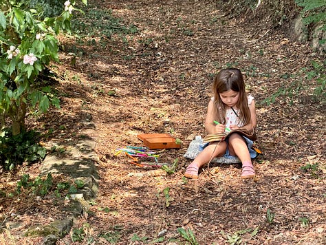 A grid of six summer photos. Top row: a boy kicking a soccer ball in a tree-lined field; a young girl paddling a small inflatable kayak on a river beneath a stone arched bridge; a girl in a pink fairy dress walking a sun-dappled forest path. Bottom row: a girl sitting on a leafy forest slope doing a beading craft; a child rowing a small boat on a calm green river; a boy and girl painting with watercolors at a table set with brushes and a star-patterned cloth.