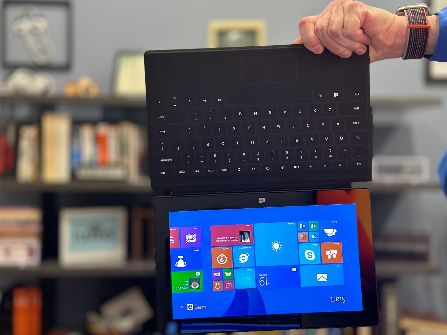 Microsoft Surface being held by the Touch Cover attached to the device by magnets. Microsoft Surface being held by the Touch Cover attached to the device by magnets.