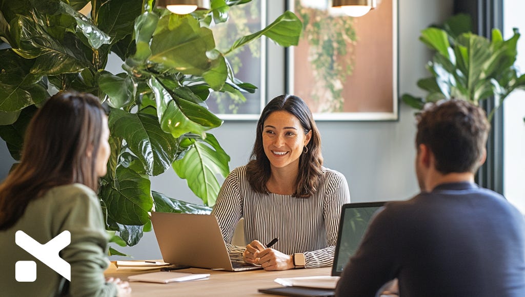 woman-leader-in-conversation-with-two-coworkers-in-a-conference-room