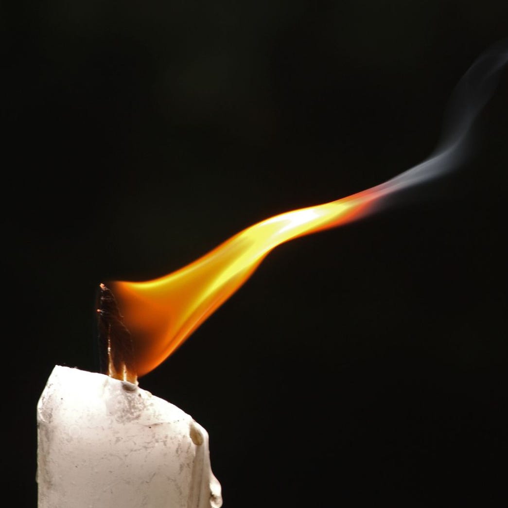 The Whispering Candle logo