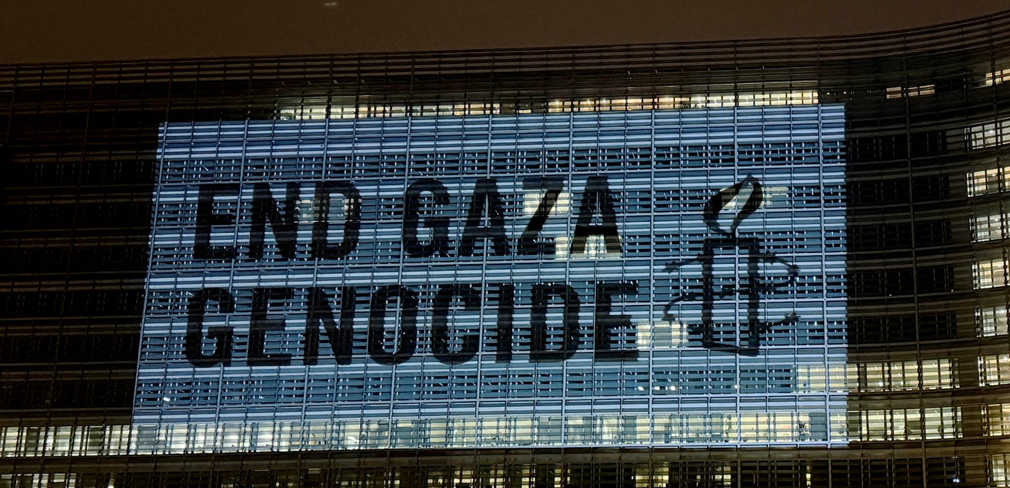 Projection on the European Commission building at night-time that says 'End Gaza genocide'