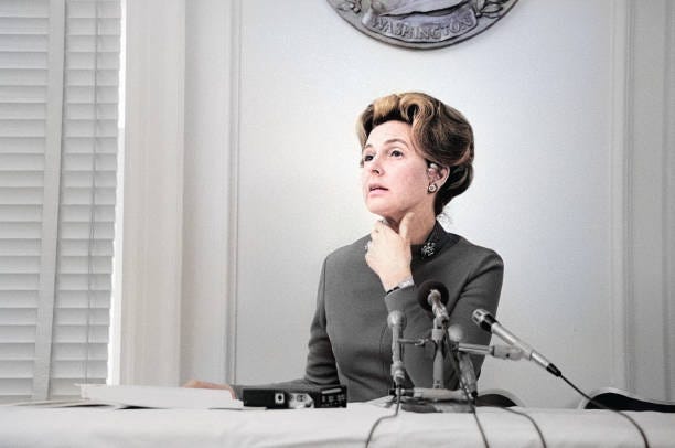 Phyllis Schlafly, chairwoman of the Stop ERA organization, seated at table, behind microphones, Marion S. Trikosko, U.S. News & World Report Magazine...