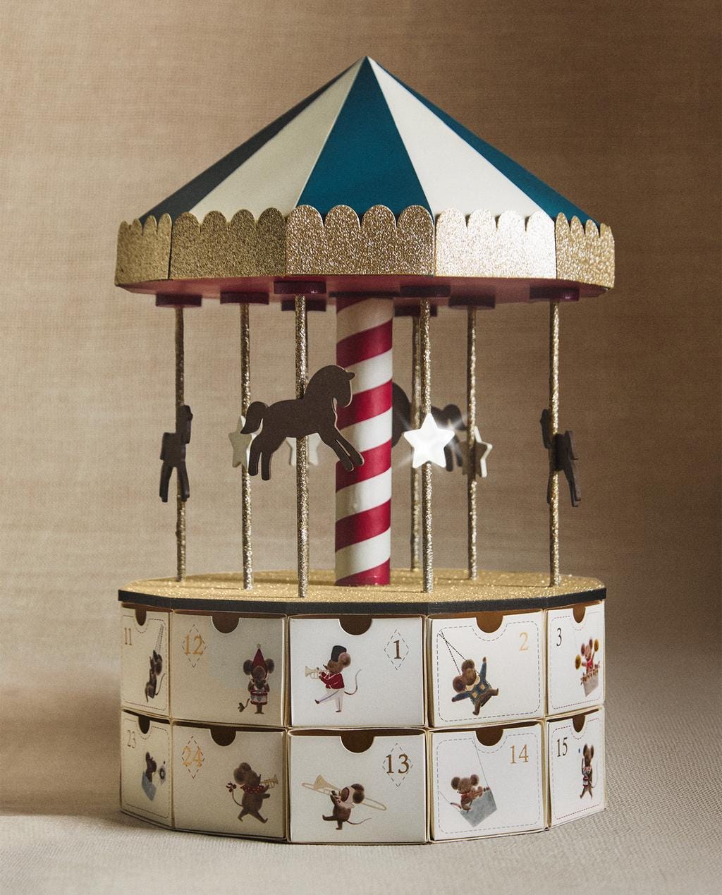 Multicolor carousel-shaped Advent calendar with 24 numbered windows and horse and star figures.