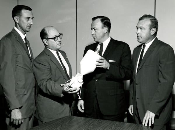 NASA modeler holding a 1962 Lunar Excursion Module concept model, together with colleagues (Credit: NASA) NASA modeler holding a 1962 Lunar Excursion Module concept model, together with colleagues (Credit: NASA)
