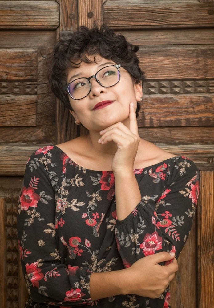 woman leaning against door while holding her cheek