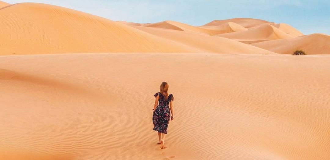 woman walking at desert woman walking at desert