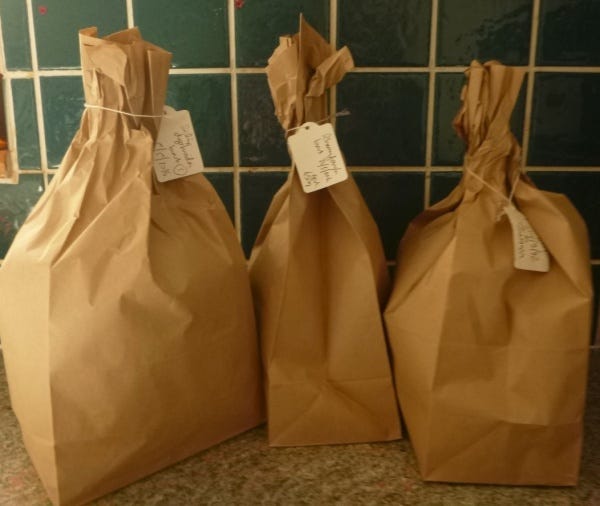 Images of brown bags containing dried herbs with handwritten labels