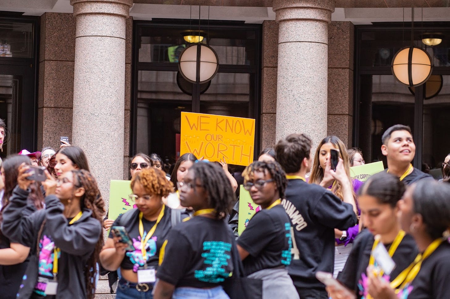 A crowd of students at the Youth Capitol Takeover event in 2023. With a focus on a sign that reads, " We Know Our Worth!" A crowd of students at the Youth Capitol Takeover event in 2023. With a focus on a sign that reads, " We Know Our Worth!"