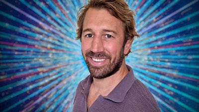 A head and shoulders shot of Chris Robshaw, smiling to camera wearing a grey/brown polo shirt