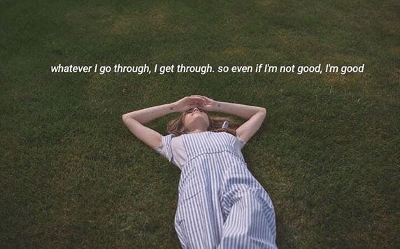 This may contain: a woman laying in the grass with her hands on her head and an inspirational quote above her