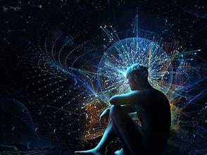 A person sitting in front of a glowing sphere

Description automatically generated