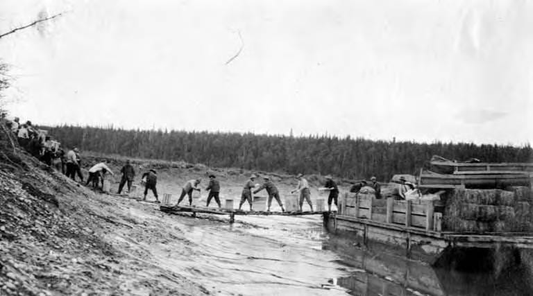 Unloading freight on the mud flats at the mouth of Ship Creek in Alaska, circa 1915. Unloading freight on the mud flats at the mouth of Ship Creek in Alaska, circa 1915.