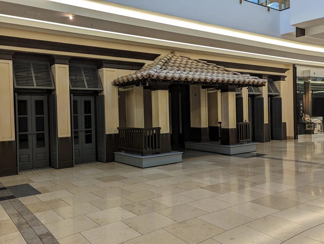 The entrance of a mall Hollister. It has a strange terracotta roof.