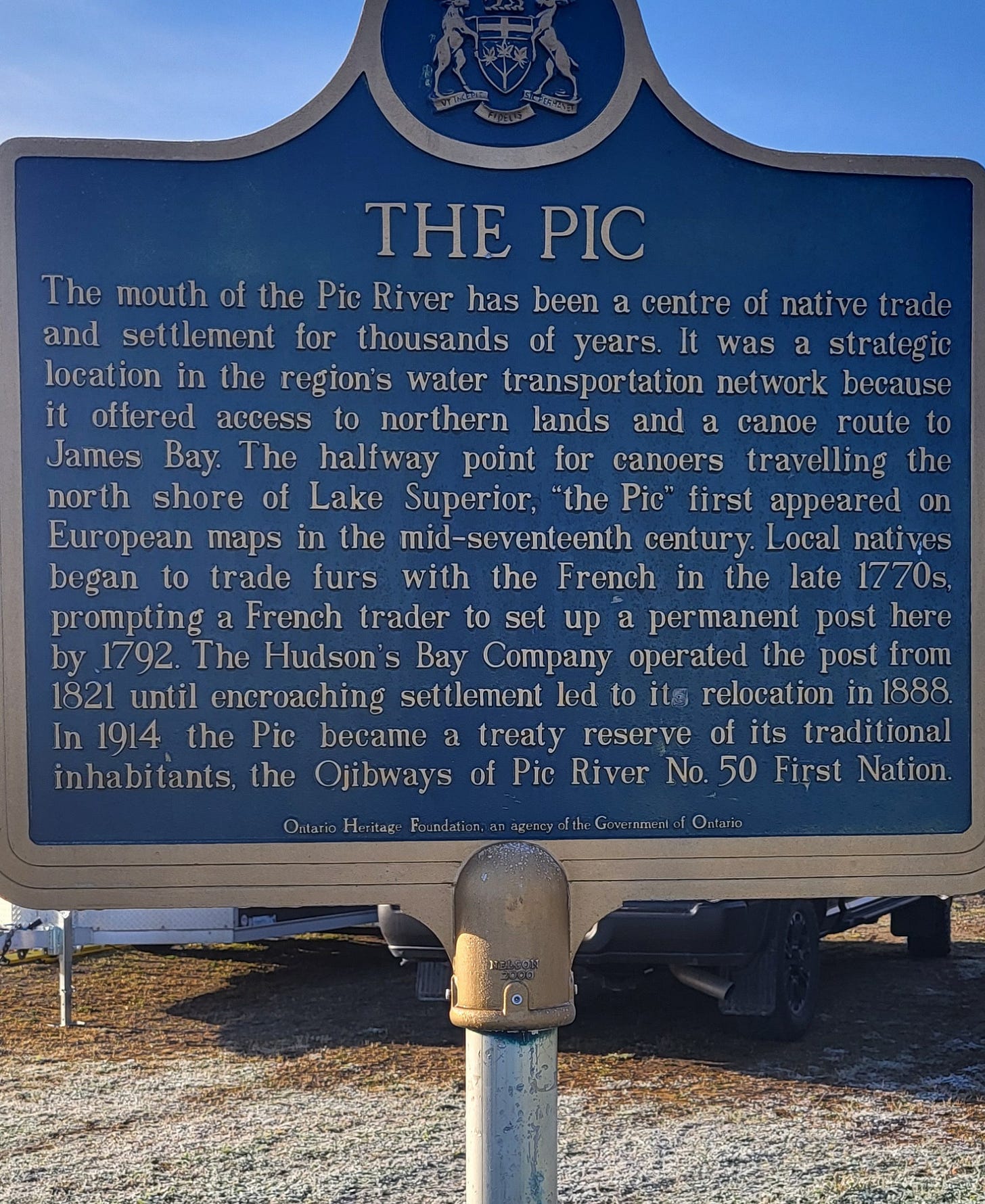A close-up of a historical marker about the Pic River's role as a halfway point for canoe travel and the fur trade on the North Shore.
