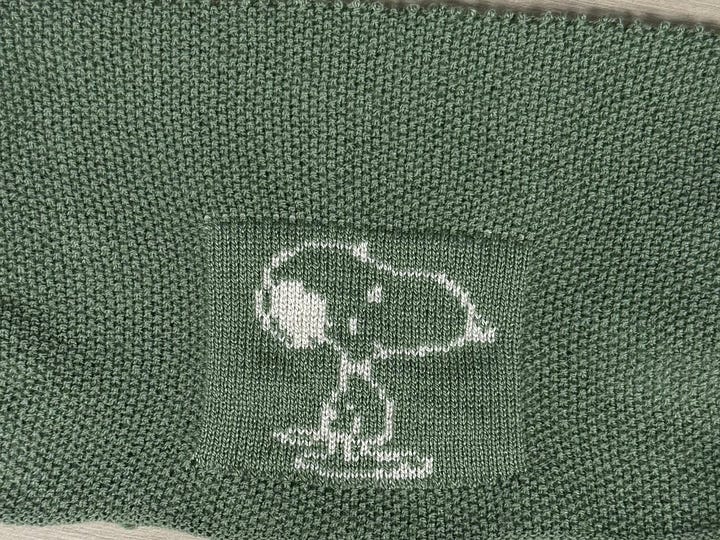 top left: a blue and maroon bag. top right: a grid of animals with a cat, dog, gorilla and the text "UIST" across the top and "2025" going down the side in yellow and purple yarn. Bottom left: snoopy knit in seed stitch, bottom right: swirly yellow lines on purple background