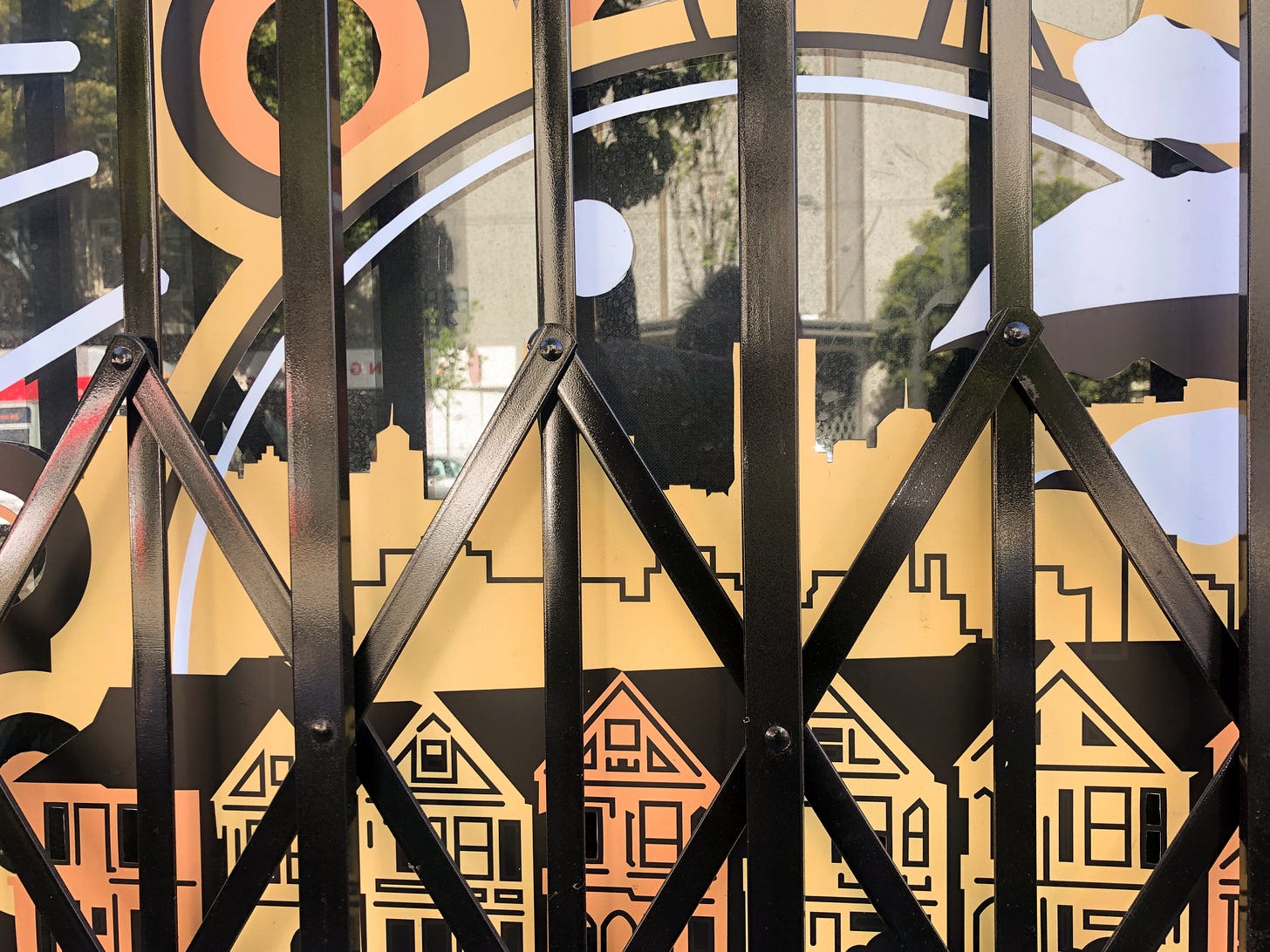 Photograph of a painted window behind a security gate