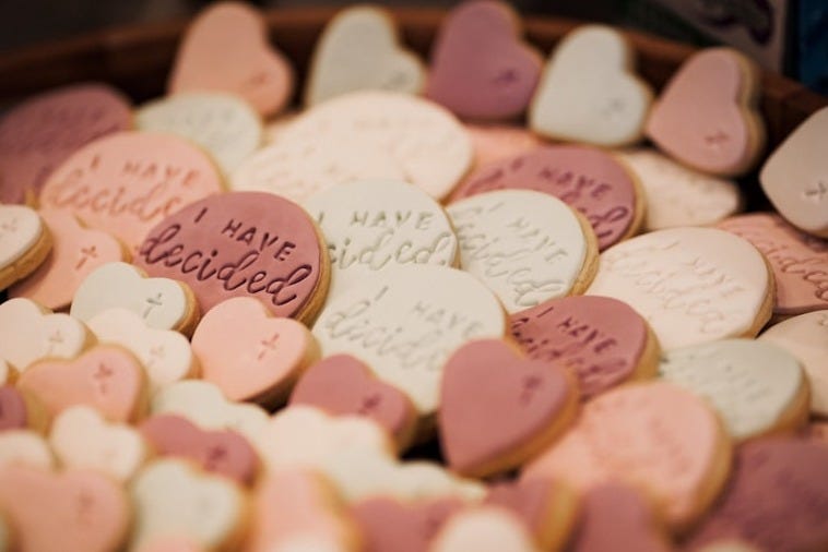 a pile of pink and white heart shaped candies