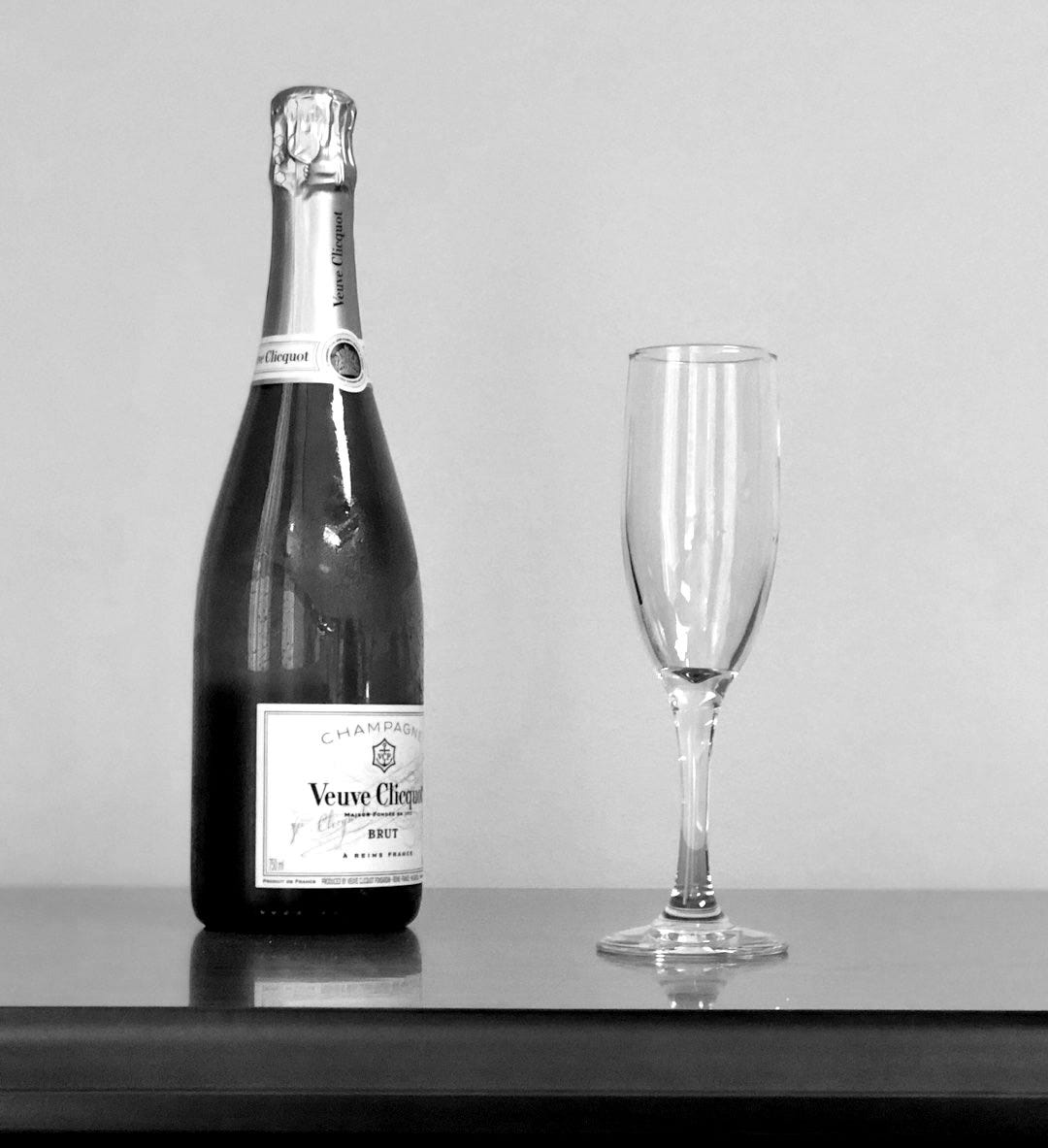 wine bottle and flute glass on table wine bottle and flute glass on table