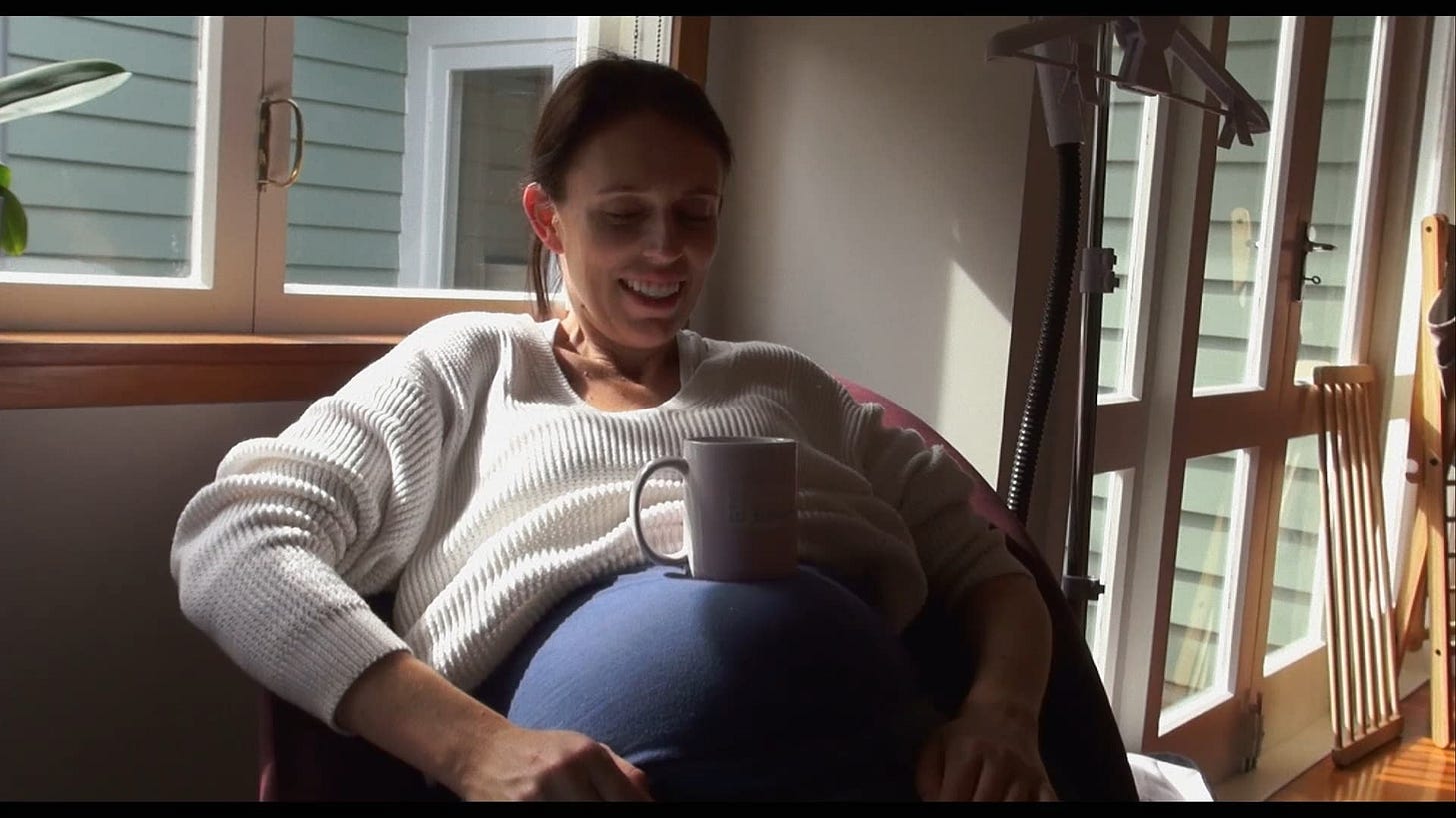 Jacinda Ardern sitting with a mug on her belly, in a clip from a documentary - Prime Minister - about her tenure. Jacinda Ardern sitting with a mug on her belly, in a clip from a documentary - Prime Minister - about her tenure.