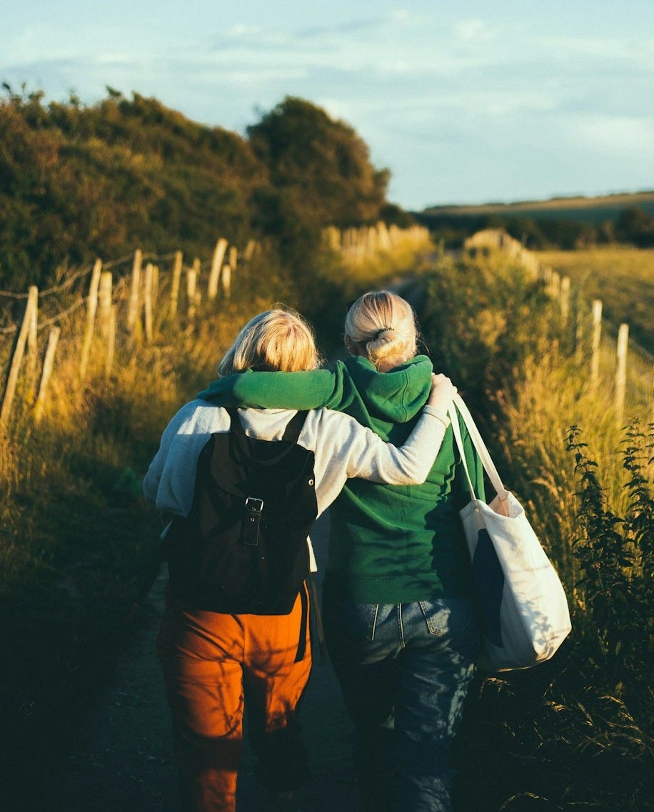two women walking together outdoor during daytime