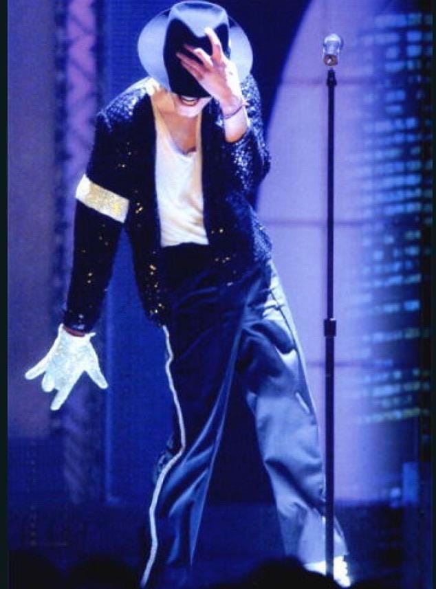 a photo of Michael Jackson, dancing onstage, wearing only one sparkly white glove.