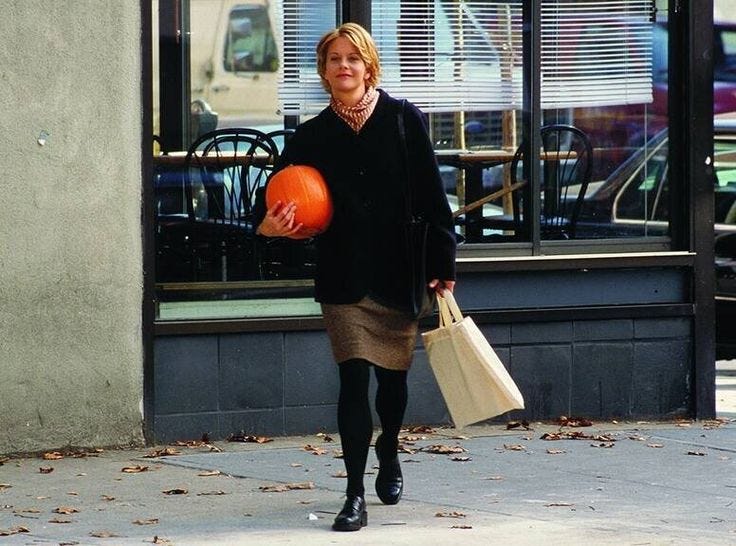 This may contain: a woman walking down the street with an orange ball in her hand