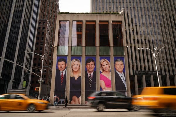The News Corp building in New York, with large images of Fox News personalities on display.