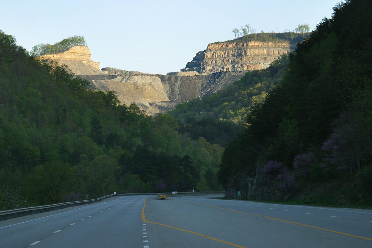 A leveled, terraced mountaintop-removal coal mine above a highway in Pike County, Kentucky A leveled, terraced mountaintop-removal coal mine above a highway in Pike County, Kentucky