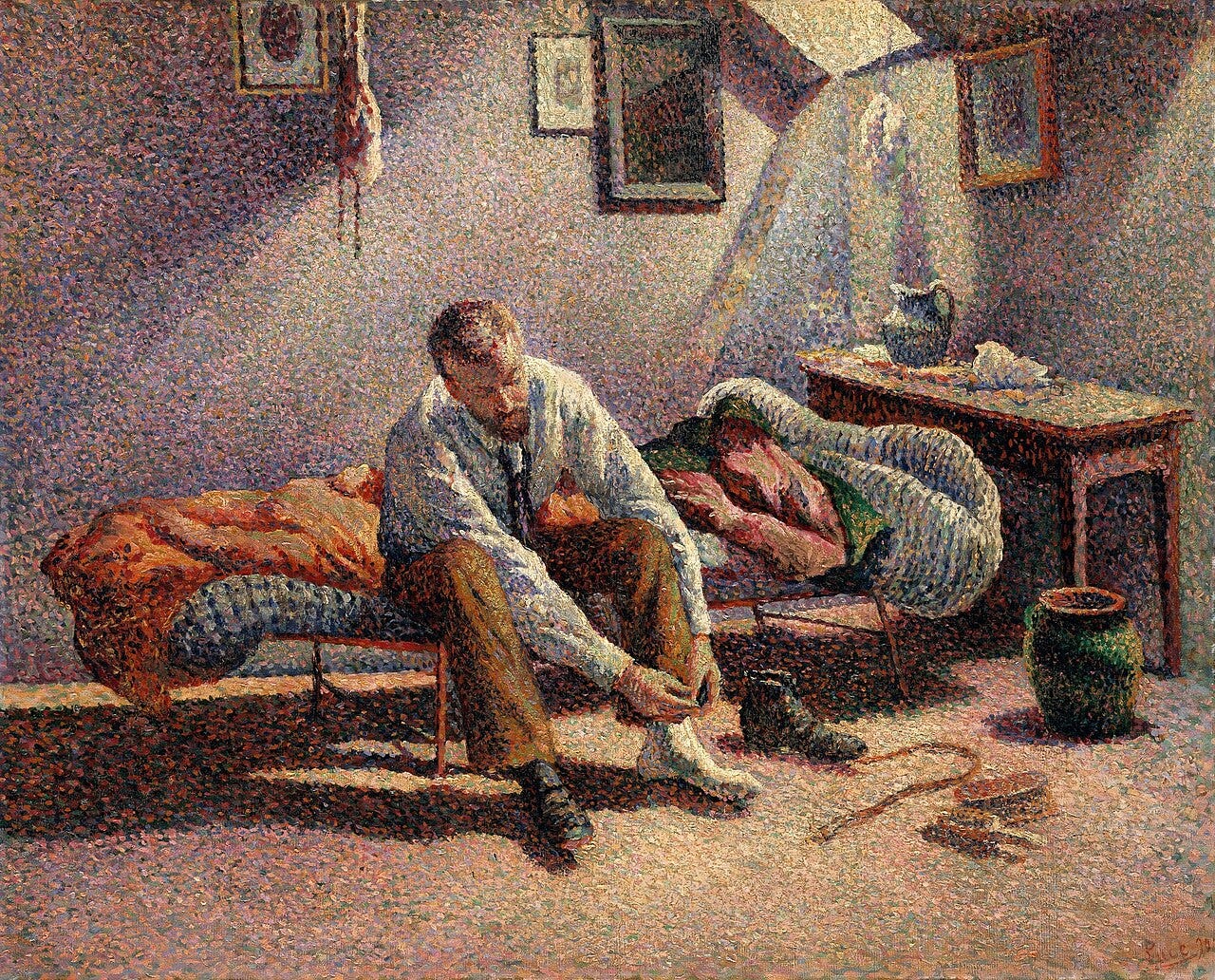 A young man dressing on his bed in cold morning light A young man dressing on his bed in cold morning light