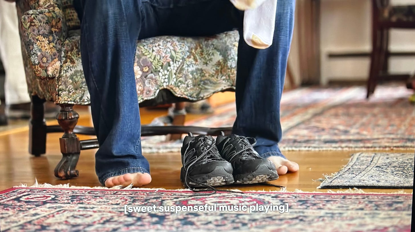 An Autistic person puts on his socks and shoes in a scene with sweet, suspenseful music.