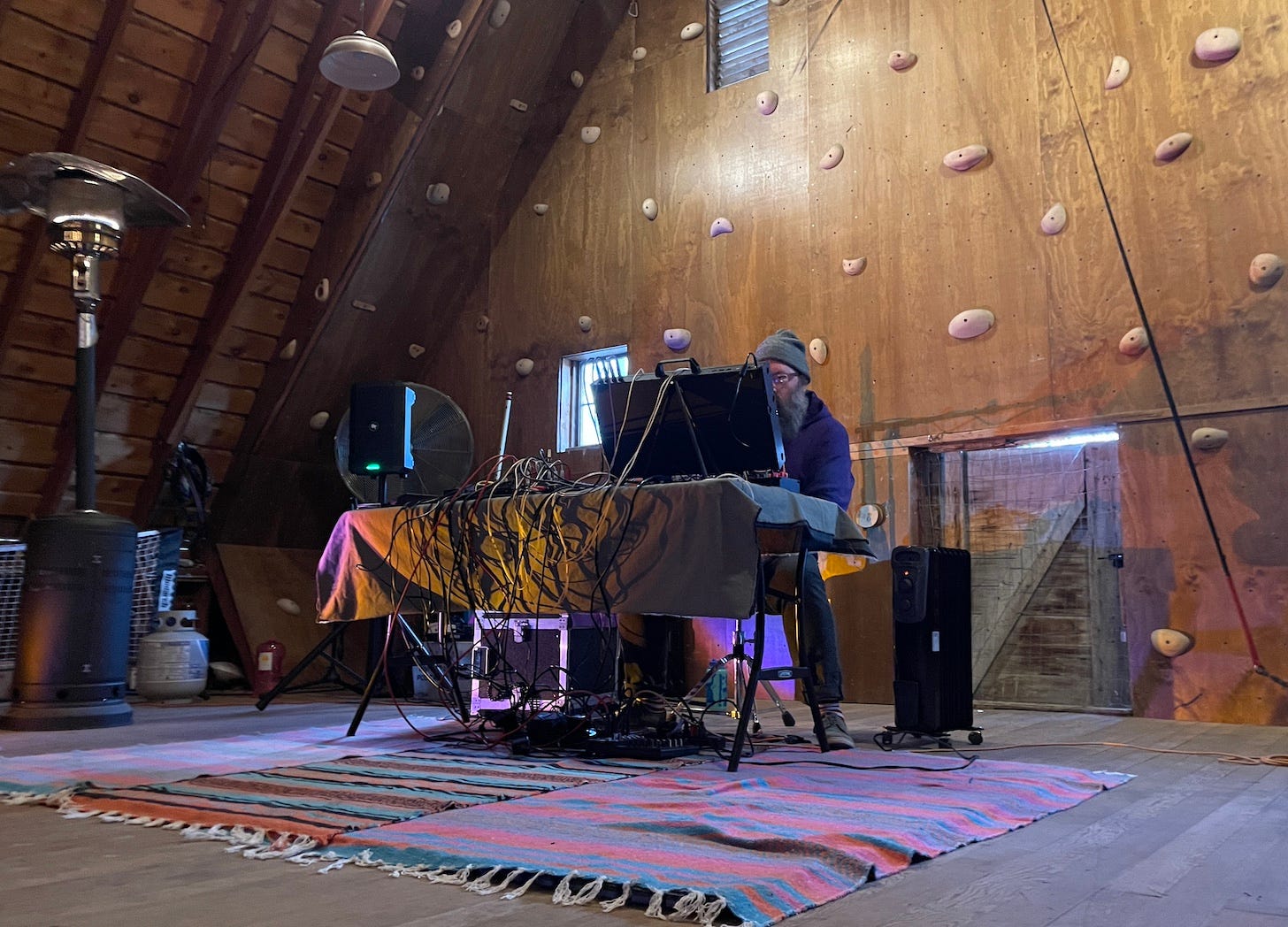 Artist Rayonism fiddles with his synths during his performance.