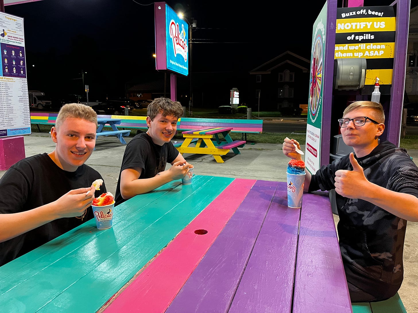three boys eating snocones