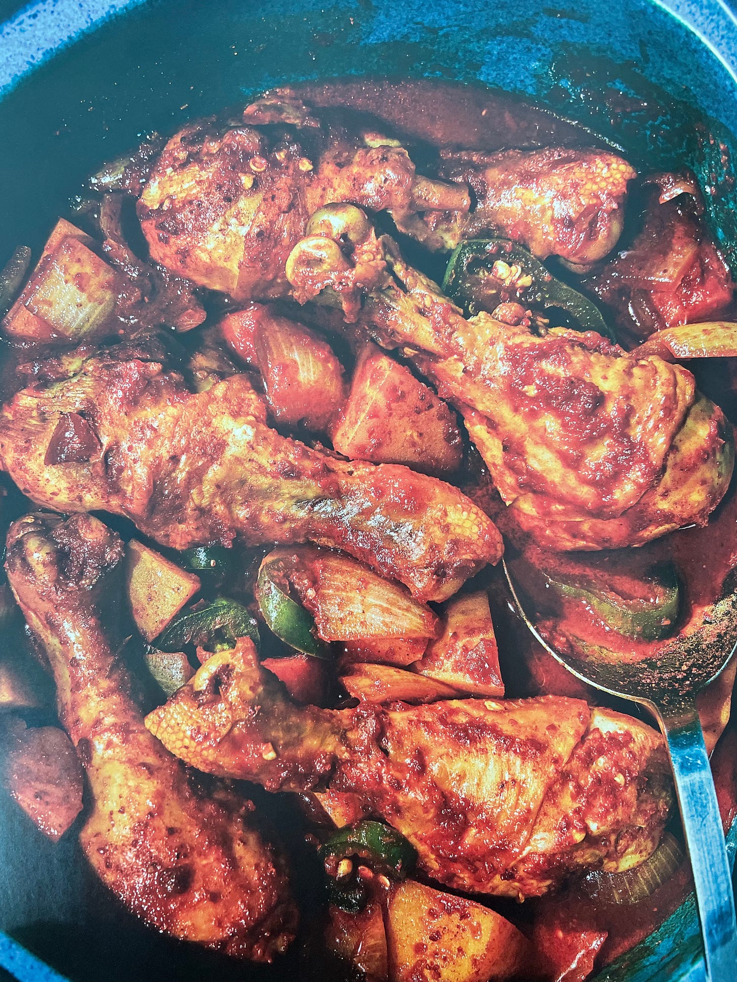 Close-up of braised chicken drumsticks in a red sauce