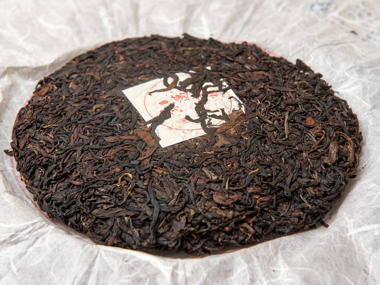 ID: Aged Jingmai black tea cake, unwrapped