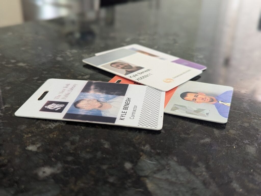 A collection of NYC building access badges from years of field engineering work