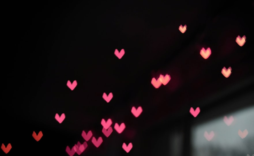 a room filled with lots of hearts hanging from the ceiling