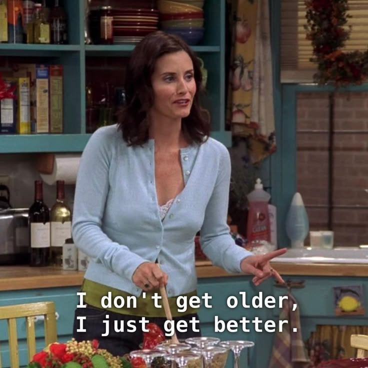 This may contain: a woman standing in a kitchen next to a table with food on it and the words i don't get older, i just get better