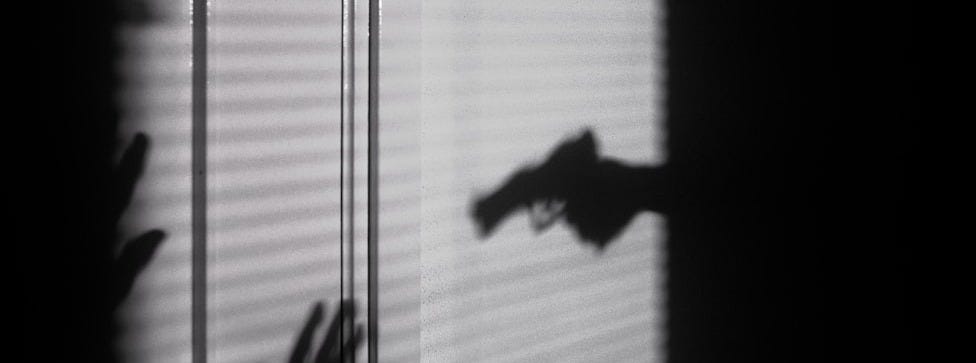 silhouette of person on window