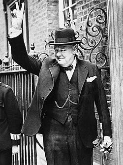 A person in a suit waving

AI-generated content may be incorrect.