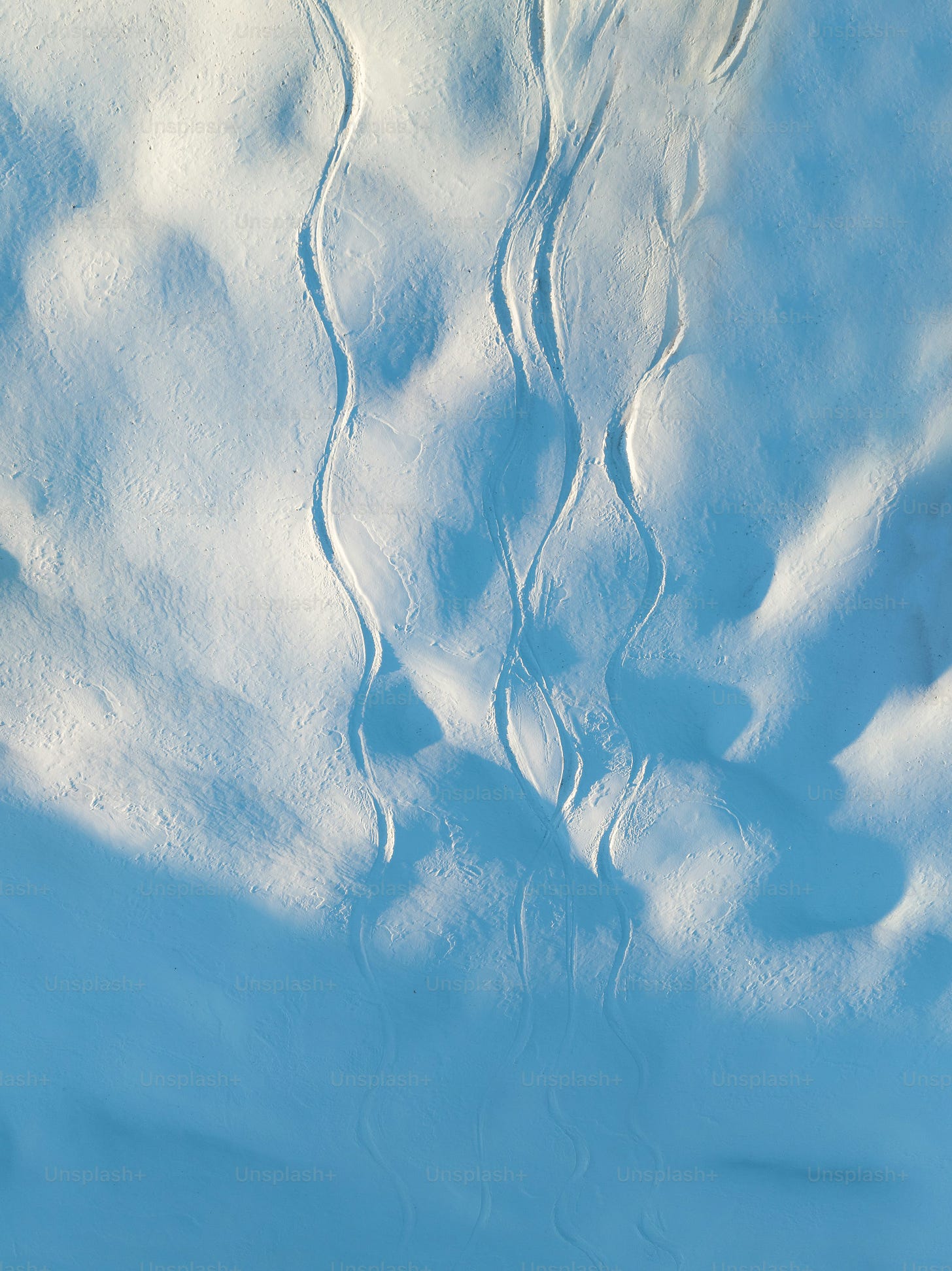 a person riding skis down a snow covered slope