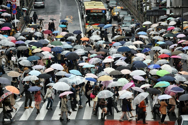 People carrying umbrellas People carrying umbrellas