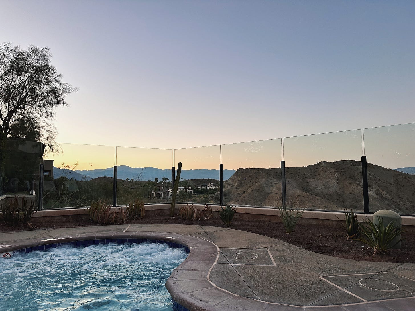 A bubbling hot tub overlooking the desert hills and distant mountains at dusk at the Ritz-Carlton, Rancho Mirage A bubbling hot tub overlooking the desert hills and distant mountains at dusk at the Ritz-Carlton, Rancho Mirage