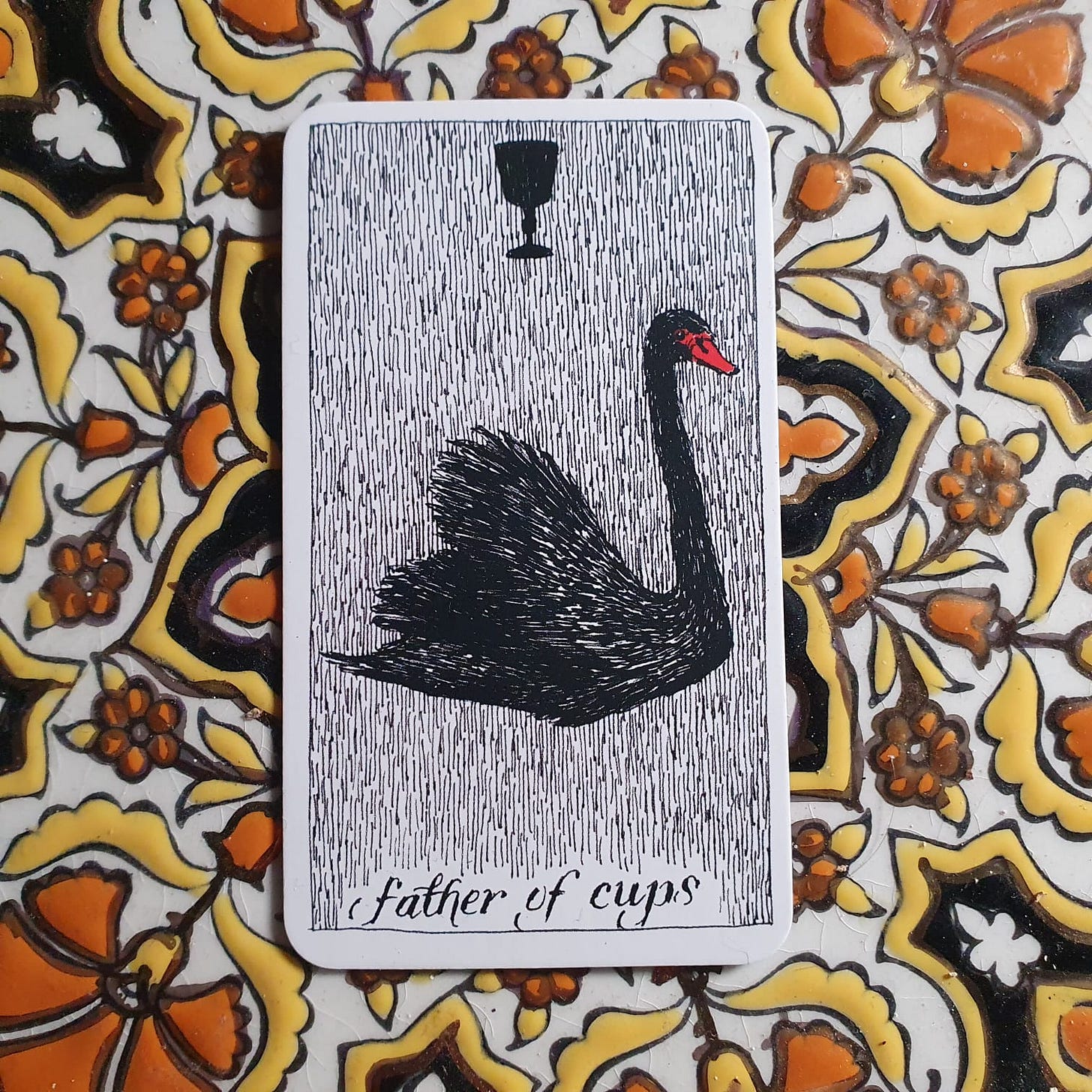 The Father of Cups from The Wild Unknown deck, depicted as a black swan