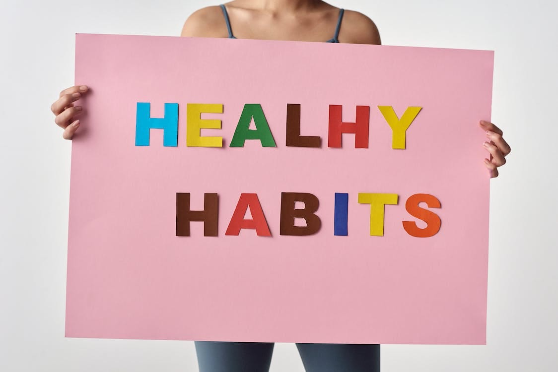 Free Person Holding a Pink Poster with Message  Stock Photo