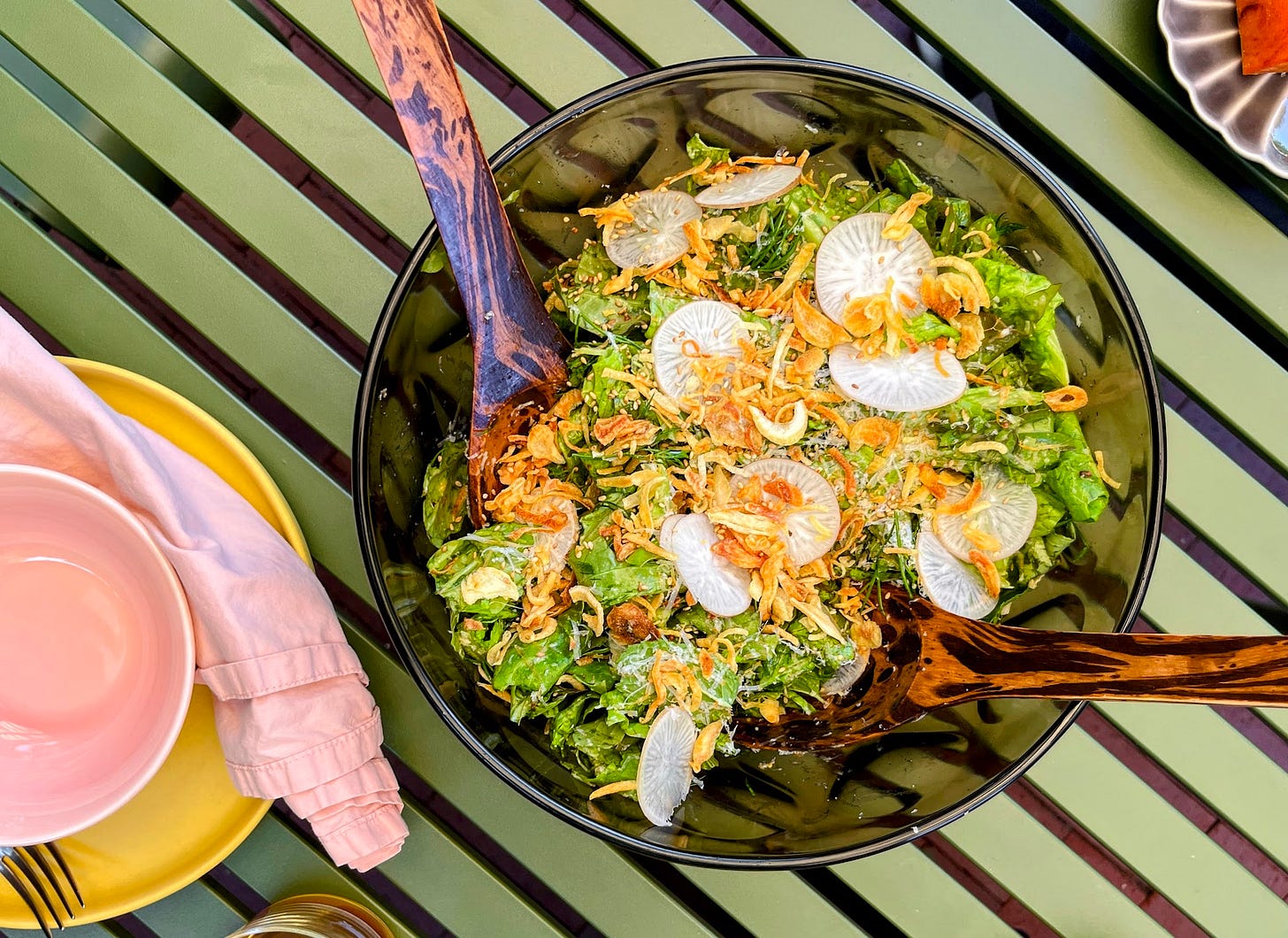 A salad on an outdoor dining table