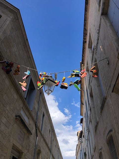 Four photos of medieval streets and buildings in Montpellier, France.