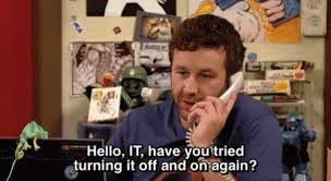 A caption of a TV show reading “Hello, IT, have you tried turning it off and on again?”