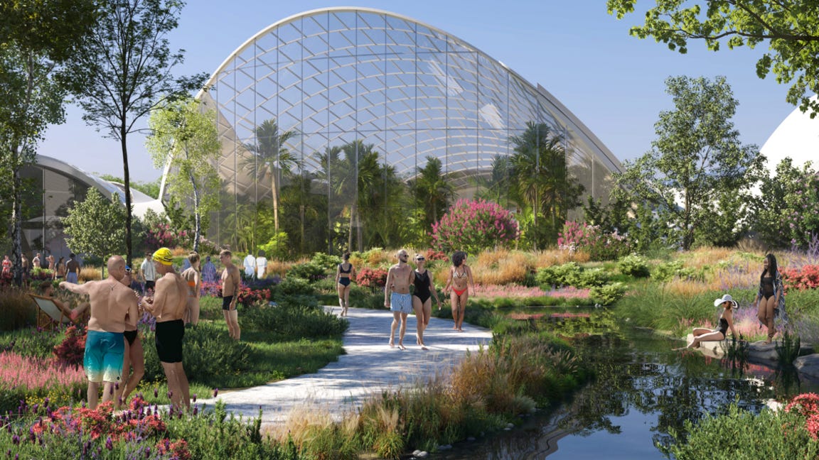 People in shorts with their tops off walk along a chalk path through a garden along an outdoor pool. A vast glass structure towers behind them on a bright sunny day. People in shorts with their tops off walk along a chalk path through a garden along an outdoor pool. A vast glass structure towers behind them on a bright sunny day.